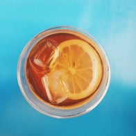 top view of a glass of iced tea with a lemon in